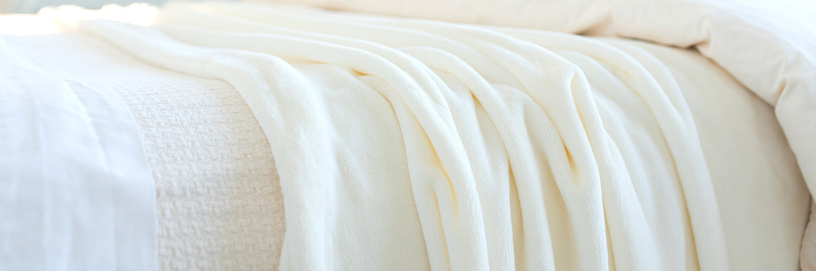 white fleece blanket on bed