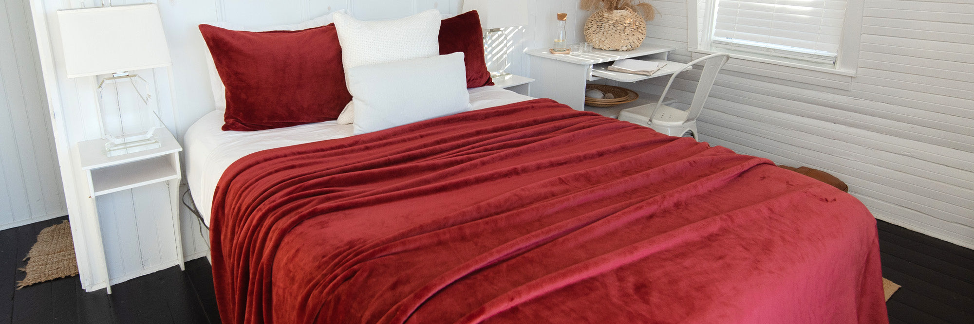 Luster Loft Fleece Blankets - A bed made with a red luster loft fleece blanket in a modern bedroom, American Blanket Company