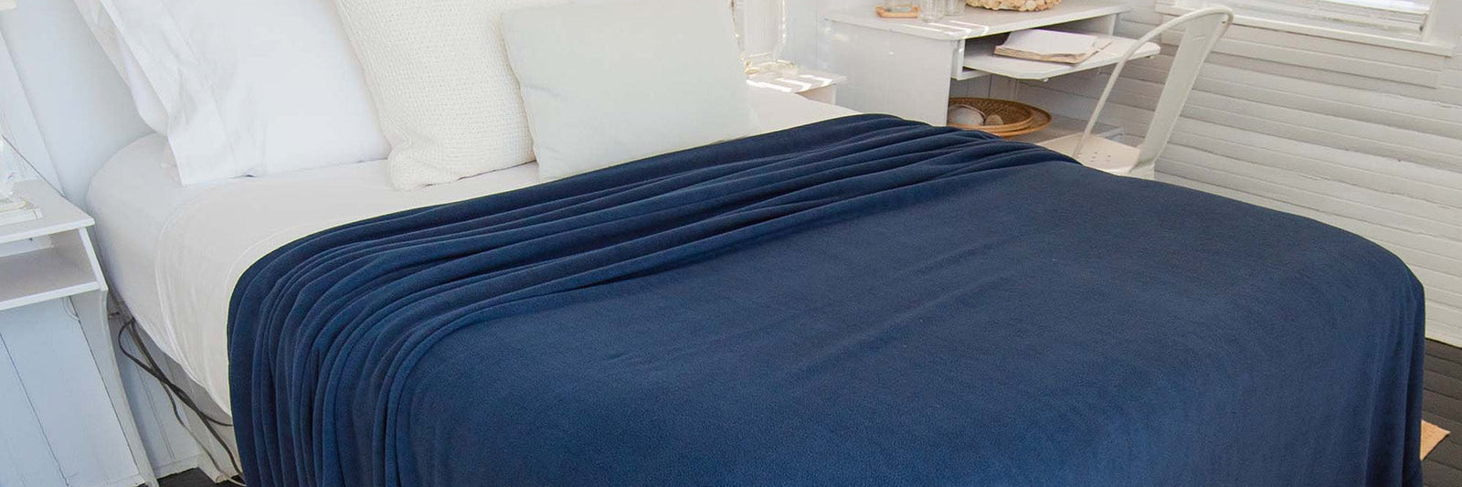 American Blanket Company - Peaceful Touch - Fleece Blankets for hot sleepers, fleece blankets for cold sleepers - pictured is a peaceful touch fleece blanket on a comfy looking bed.