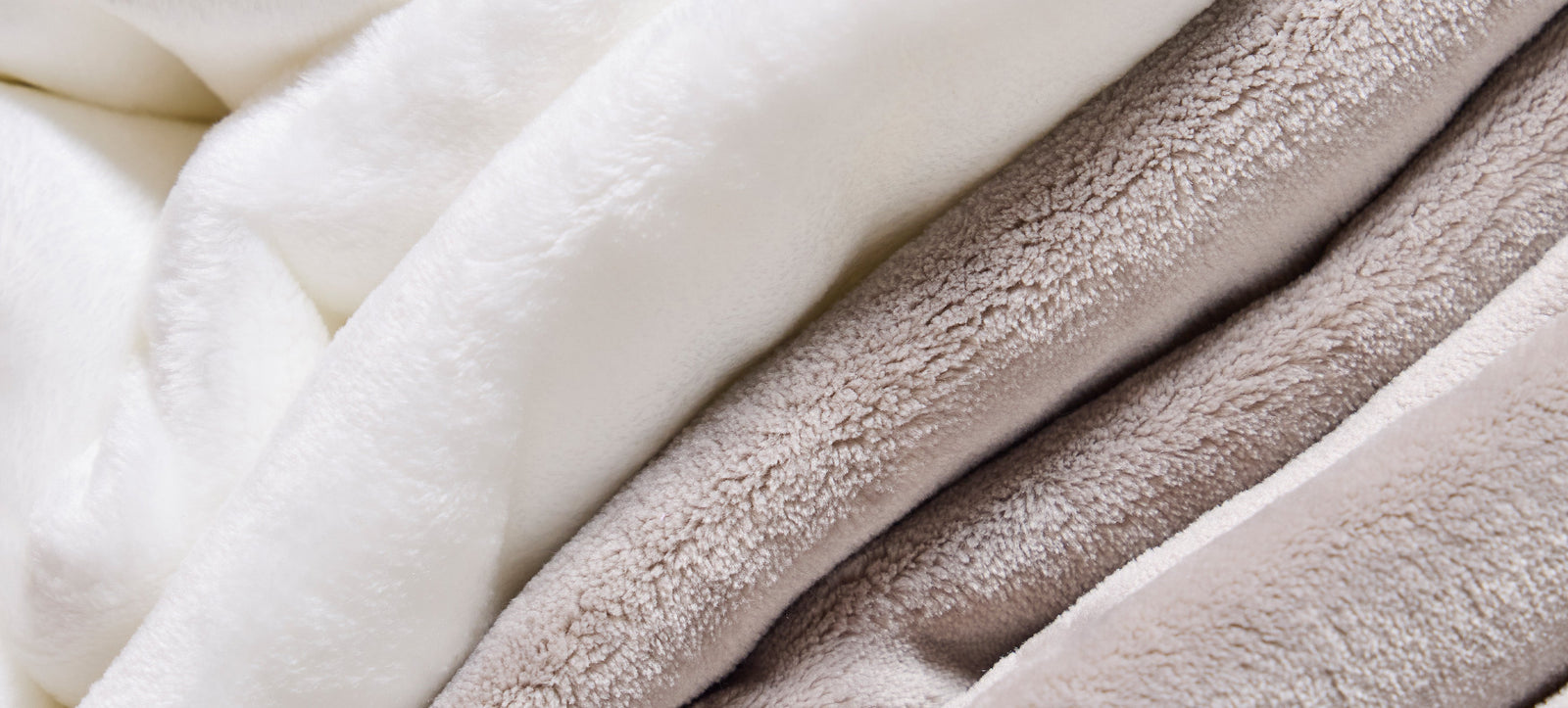 American Blanket Company - Softest Fleece Blankets - Pictured is a close up detail of cream, and beige luster loft fleece blankets showing the softness and texture