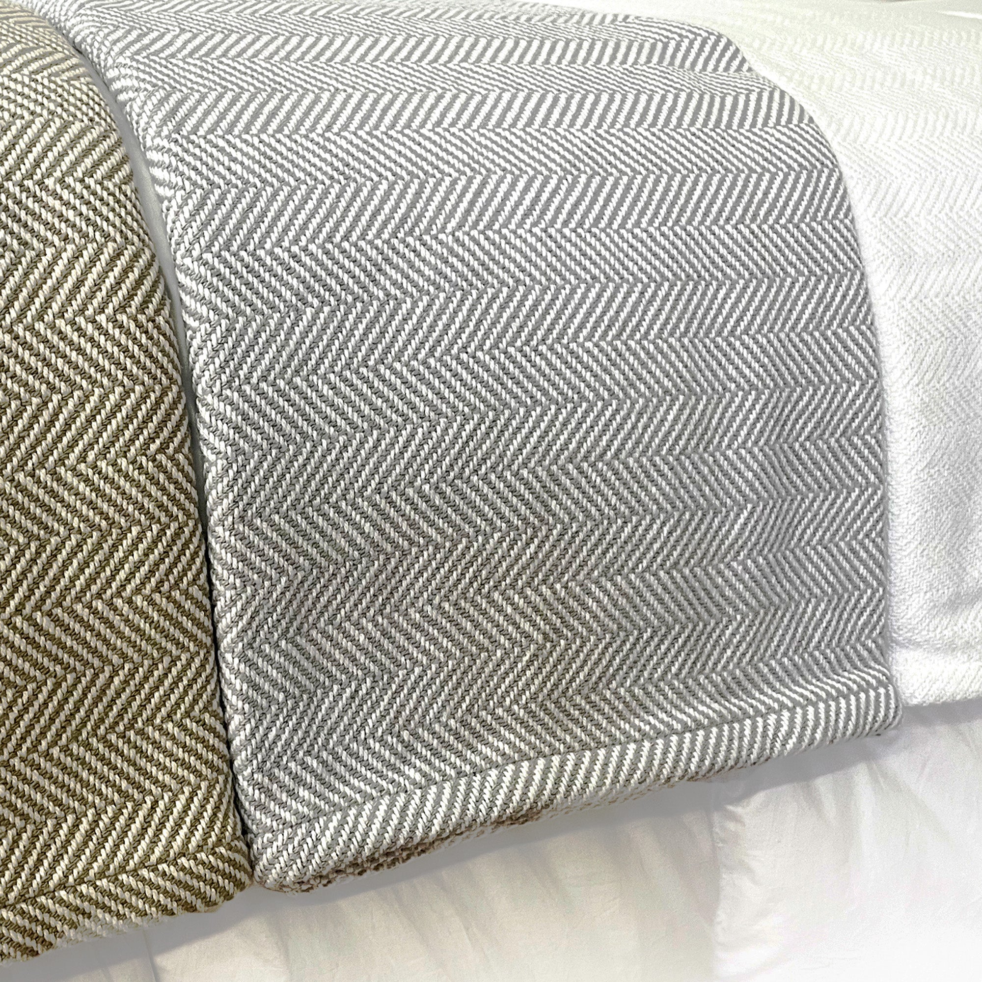 American Blanket Company - 100% Cotton Bed Blanket, Feather Weave Pattern Blanket - Three cotton blankets laid out on bed of the various blanket colors showing white, gray and white, and khaki and white in a lovely herringbone pattern.