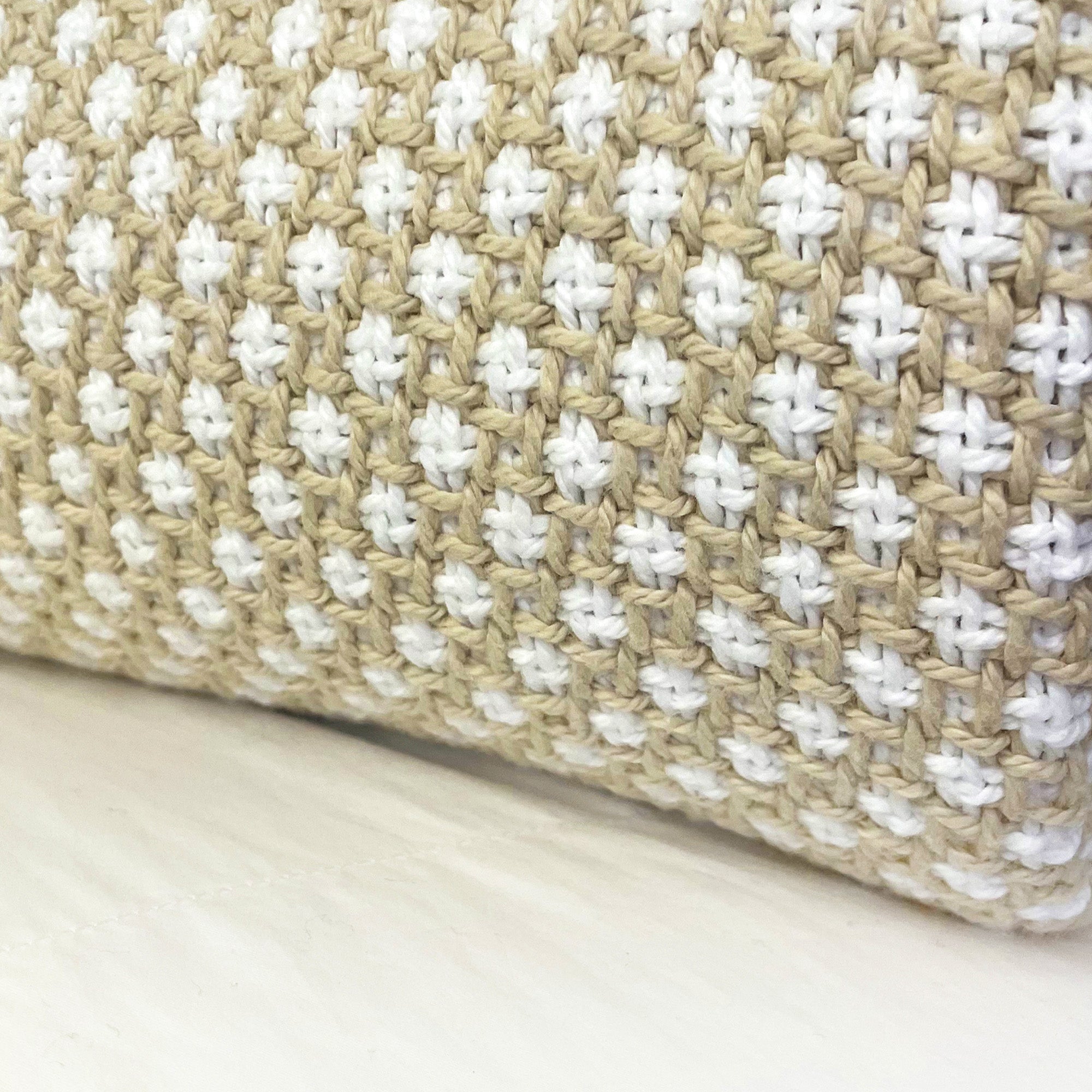 American Blanket Company - Cotton Blanket, 100% Cotton Lattice Weave Blanket - Close up of the natural and white woven pattern, focusing on the rounded fold of the blanket.