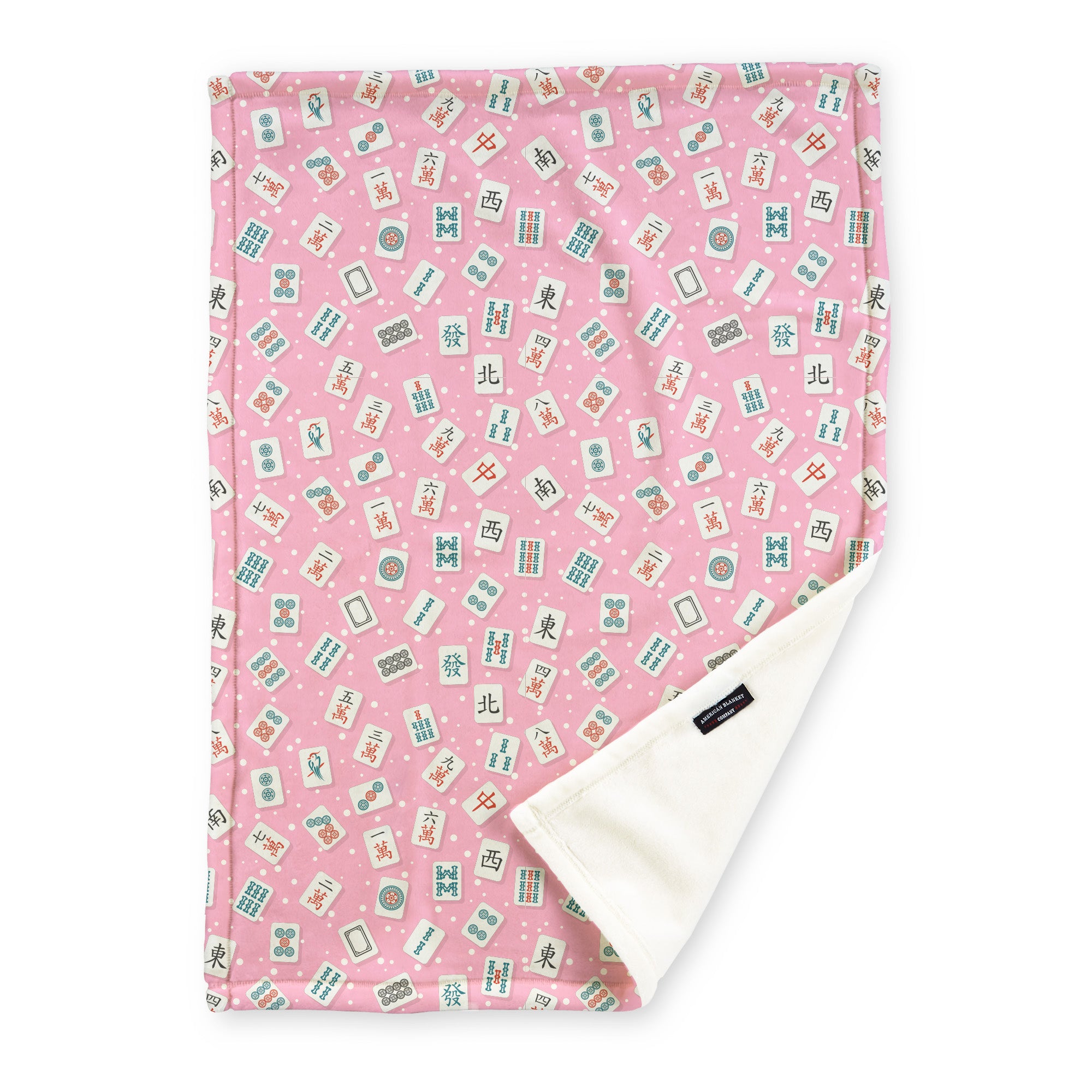 American Blanket Company - Pink Fleece Mahjong Blanket with an assortment of tiles on a pink background with soft polkadots.
