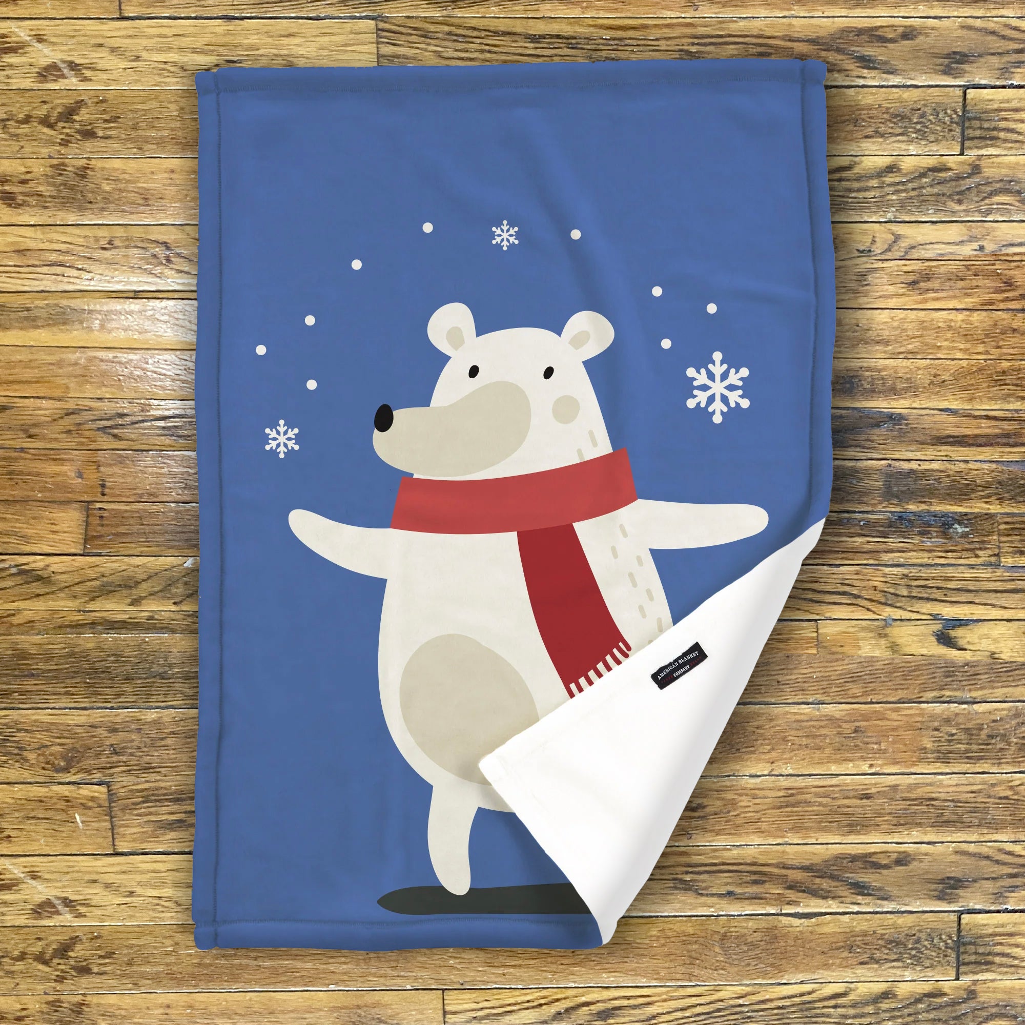 American Blanket Company - Luster Loft Fleece - A festive blue fleece throw blanket featuring a white polar bear wearing a red scarf, with snowflake decorations and a personalizable name space.