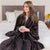 Woman in Luster Loft Fleece Blanket Wrap - Luster Loft Blanket Wrap - American Blanket Company