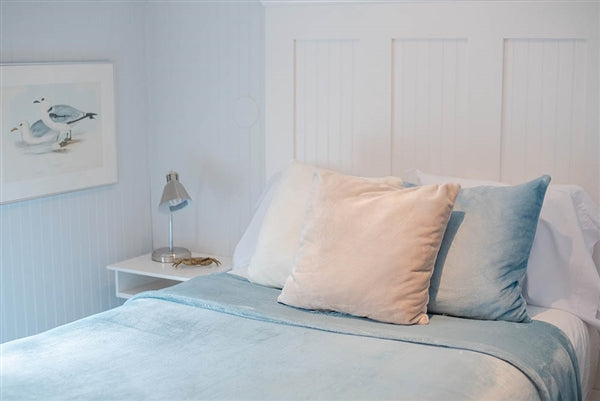 American blanket company - luster loft Fleece 17x17 throw pillow - throw pillows on a bed with a luster loft fleece blanket on the bed.