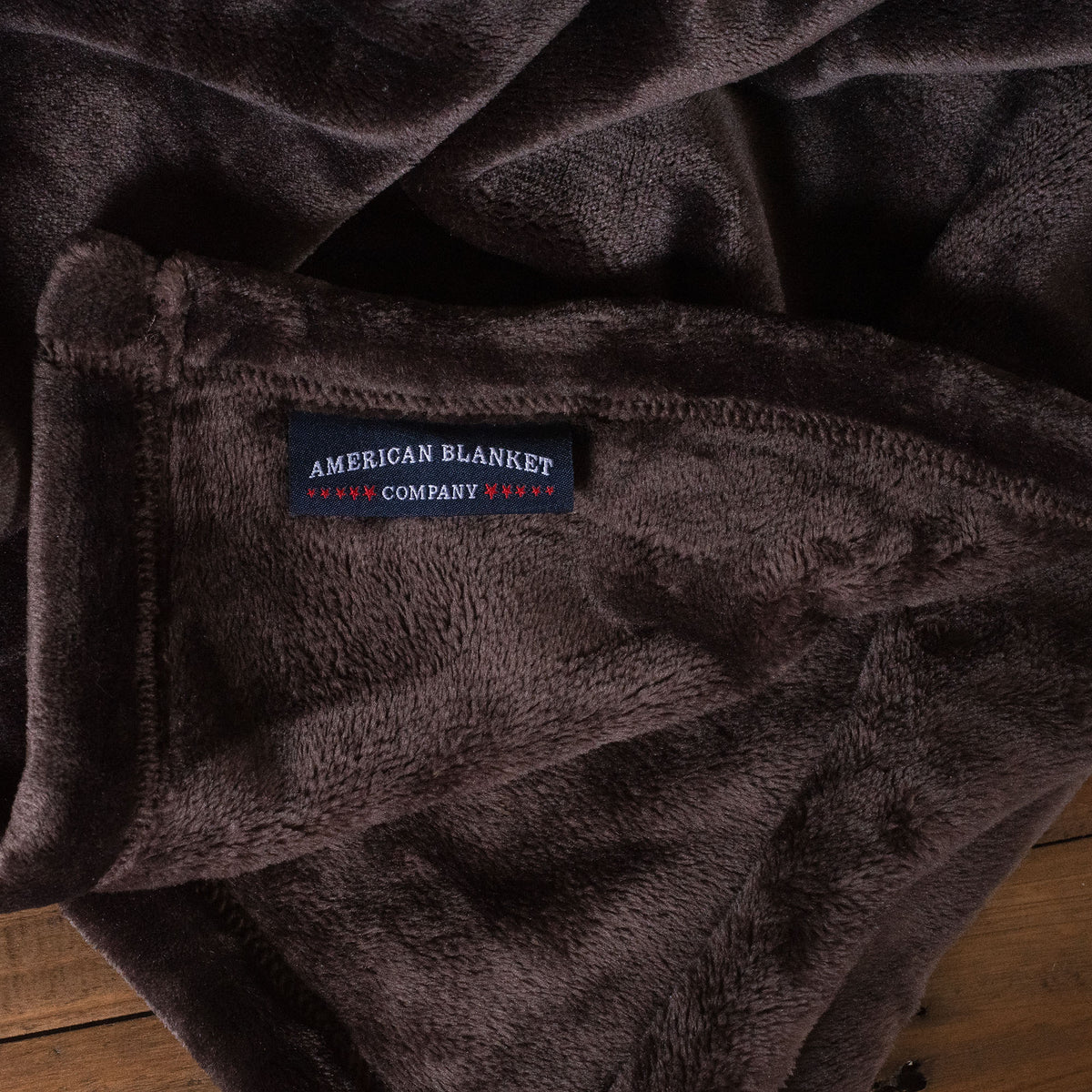 Chocolate Luster Loft Fleece Blanket On Wood -Fleece Blankets - Luster Loft - American Blanket Company