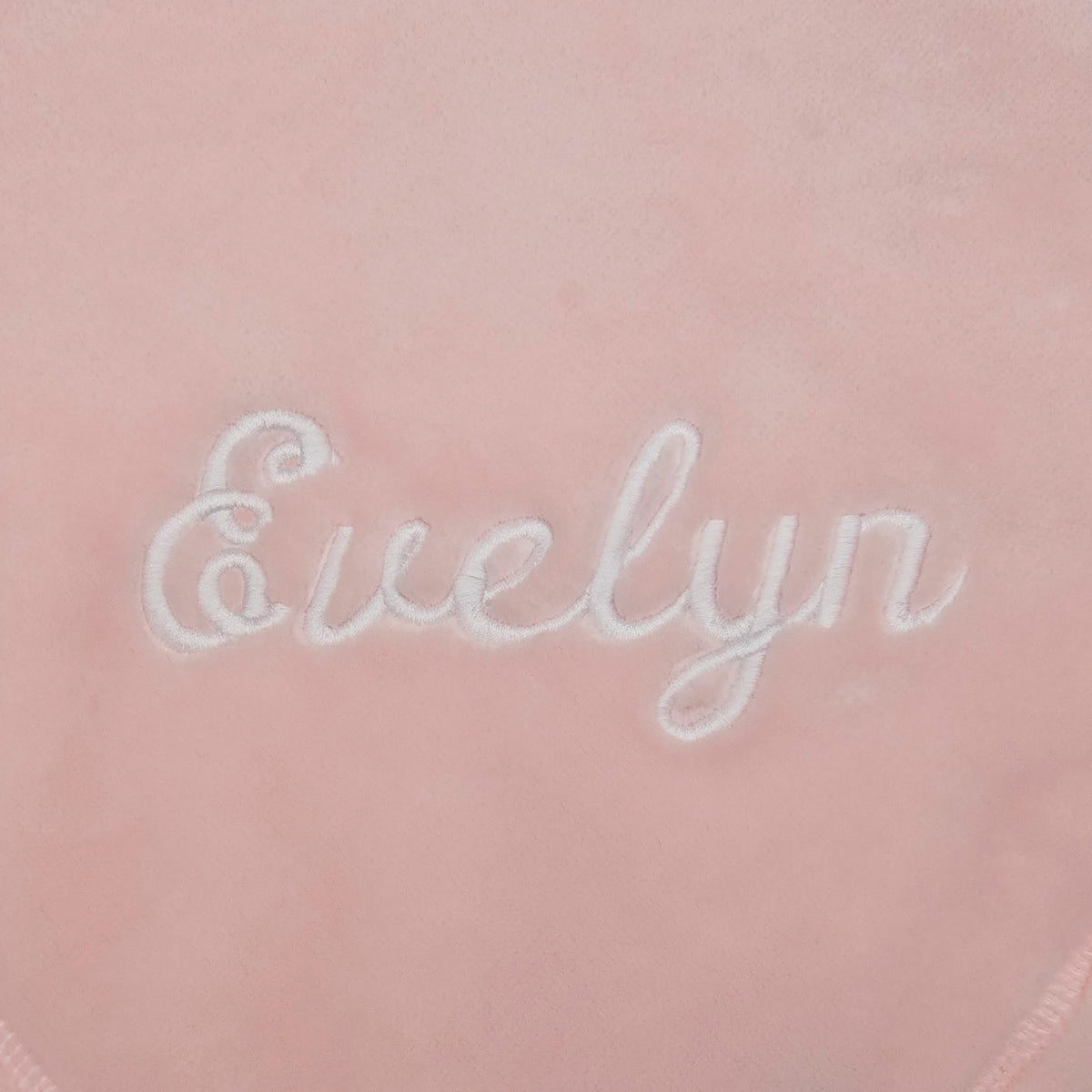 white embroidery of the name Evelyn on pink luster loft fleece - Luster Loft Fleece Blankets - Luster Loft Fleece Throws - American Blanket Company